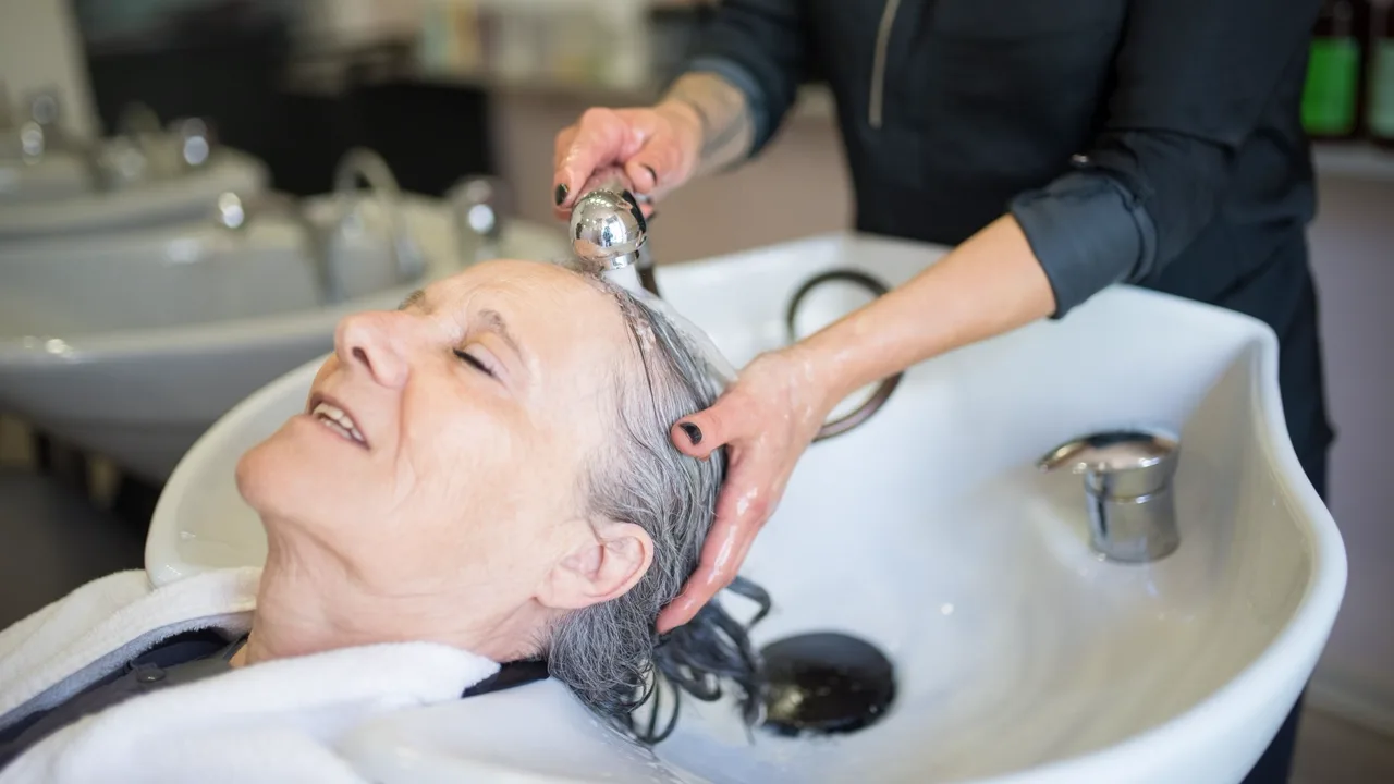 Hair being treated and rinsed at the salon basin